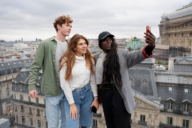 Medium shot friends taking selfie