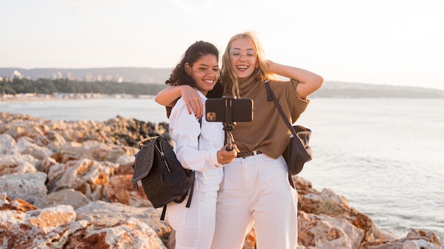 Medium shot friends taking selfies