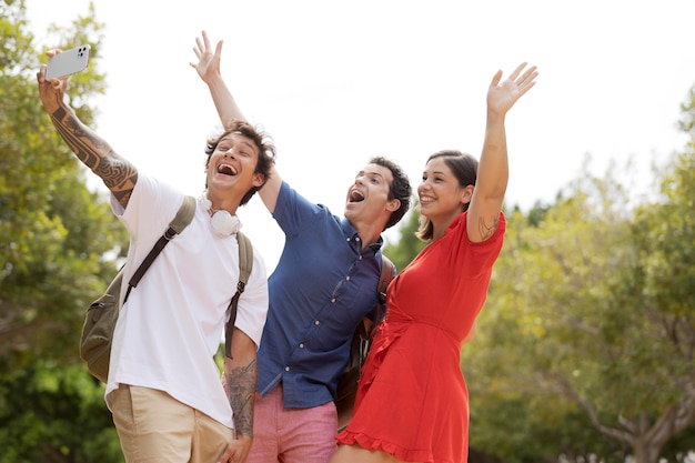 Medium shot friends taking selfies