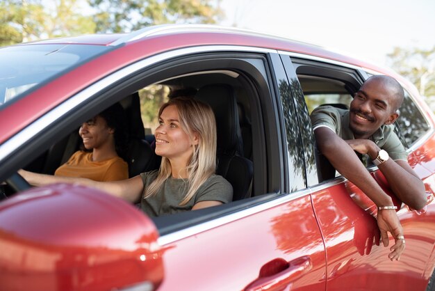 Medium shot friends traveling by car