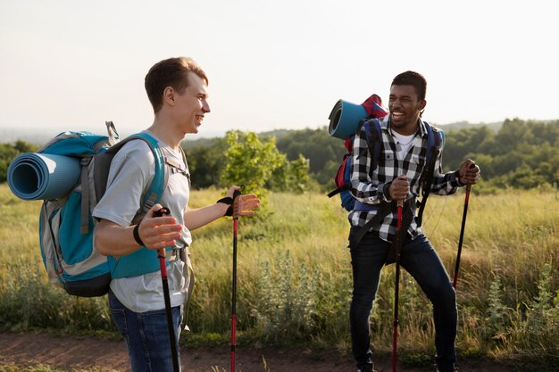 Medium shot friends with backpacks