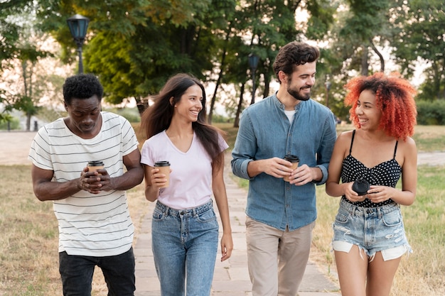 Medium shot friends with coffee cup