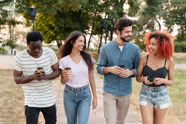 Medium shot friends with coffee cup