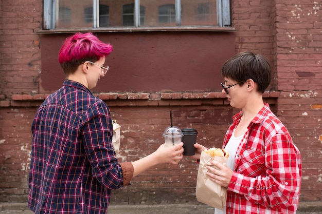 Free photo medium shot friends with coffee cups