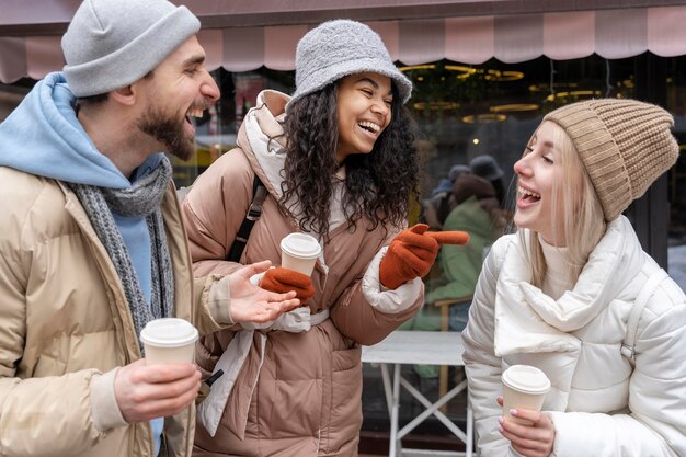 Medium shot friends with coffee cups