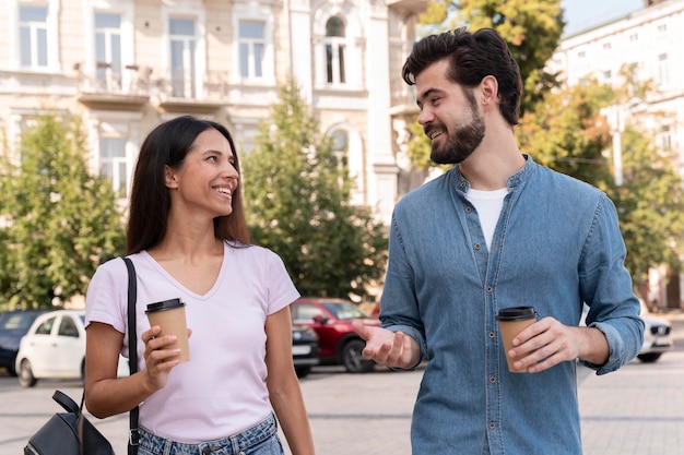 Medium shot friends with coffee cups