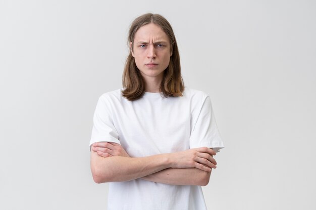 Medium shot frowning teen with crossed arms