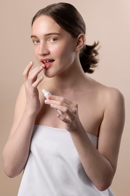 Medium shot girl applying lip balm