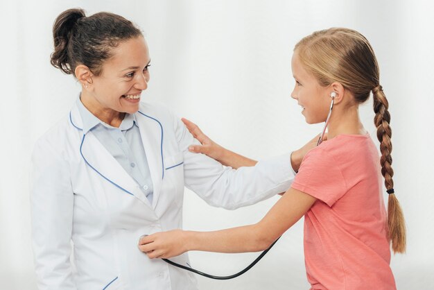 Medium shot girl checking doctor