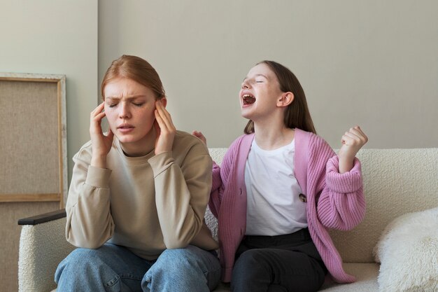 Medium shot girl on couch screaming