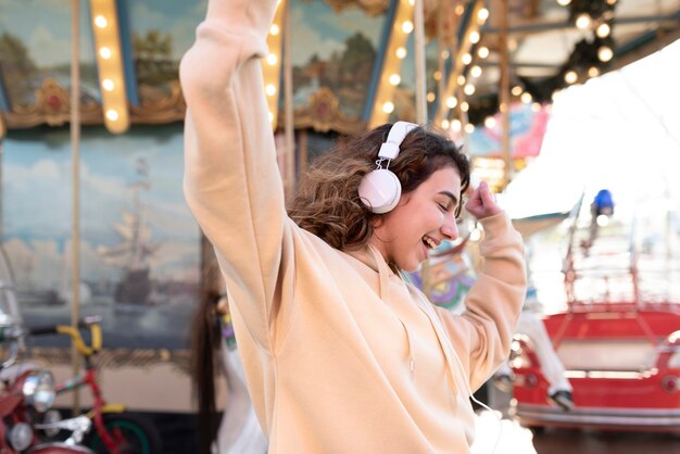 Medium shot girl dancing with headphones