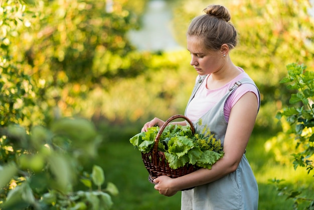 Medium shot girl holding basket