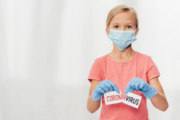 Medium shot girl holding covid19 paper