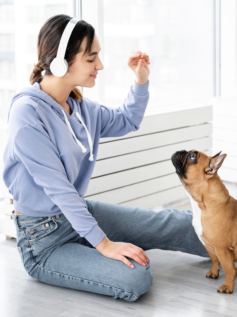 Medium shot girl holding dog treat