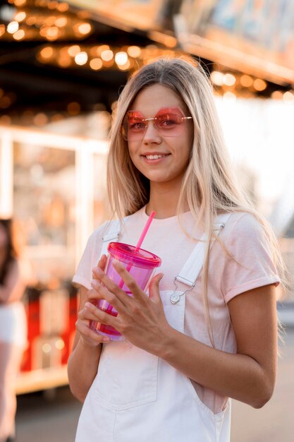 Medium shot girl holding drink