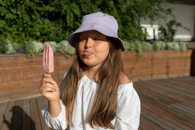 Medium shot girl holding ice cream