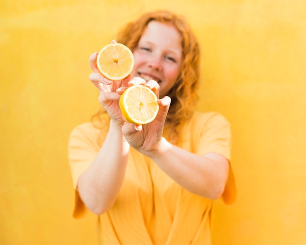 Medium shot girl holding lemons