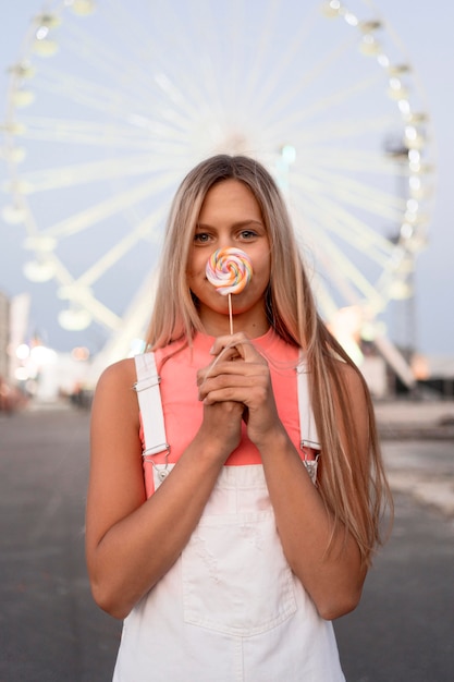 Medium shot girl holding lollipop