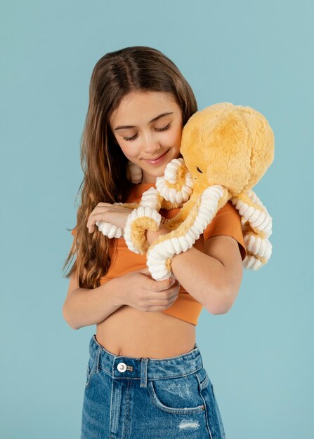 Medium shot girl holding octopus