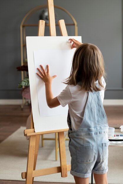 medium shot girl holding paper