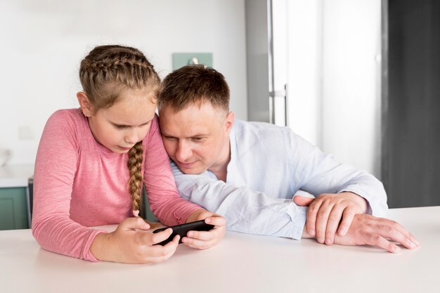 Medium shot girl holding smartphone