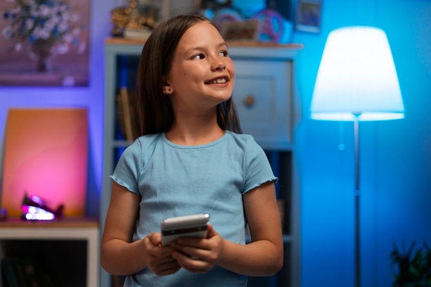 Medium shot girl holding smartphone