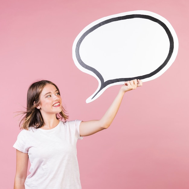 Free photo medium shot girl holding a speech balloon