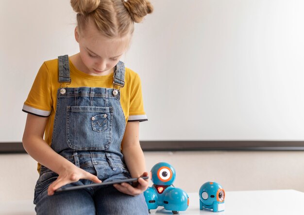 Medium shot girl holding tablet