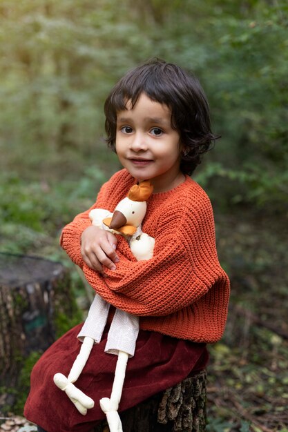 Medium shot girl holding toy