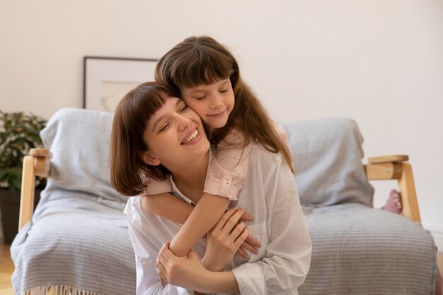 Medium shot girl hugging mother