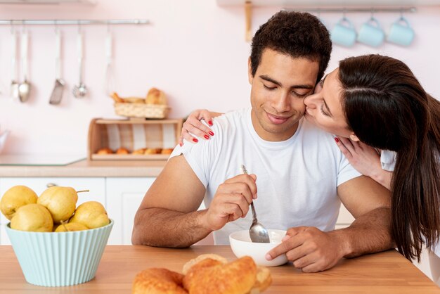 Medium shot girl kissing boy on the cheek