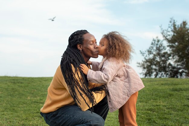 Medium shot girl kissing father