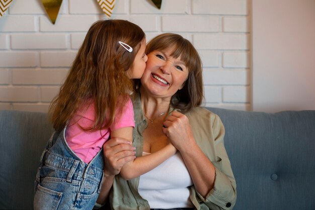 Medium shot girl kissing granny