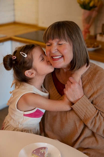 Medium shot girl kissing granny