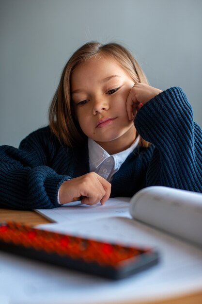 Medium shot girl learning math at school