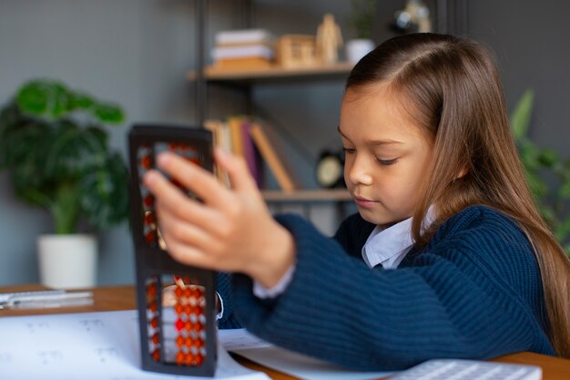 Medium shot girl learning math at school