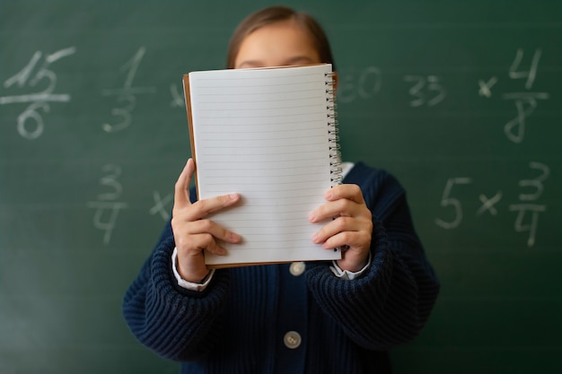 Medium shot girl learning math at school