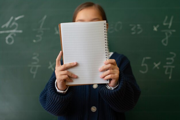 medium shot girl learning math at school