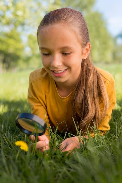 Medium shot girl observing flower