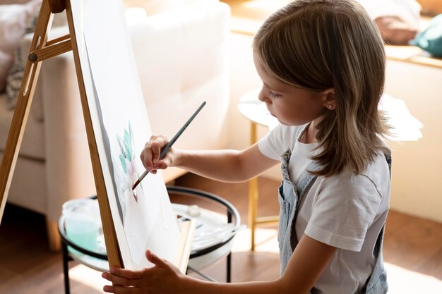 Medium shot girl painting with brush