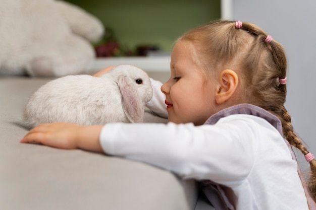 Medium shot girl playing with bunny