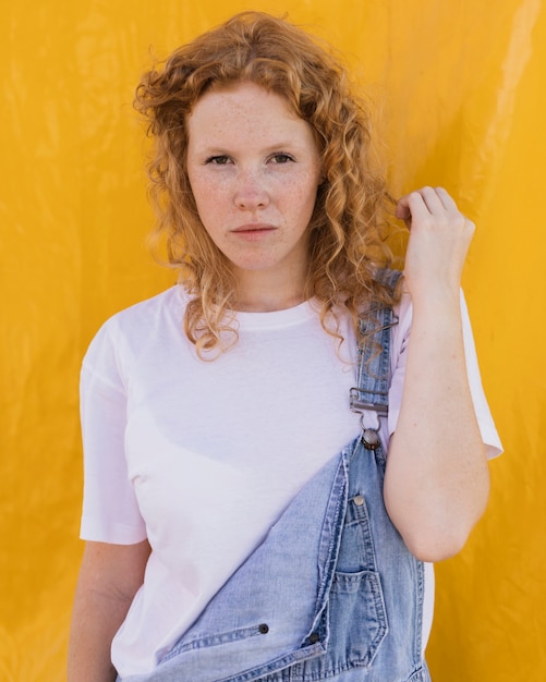 Medium shot girl posing with yellow background