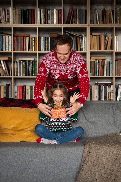 Medium shot girl receiving present