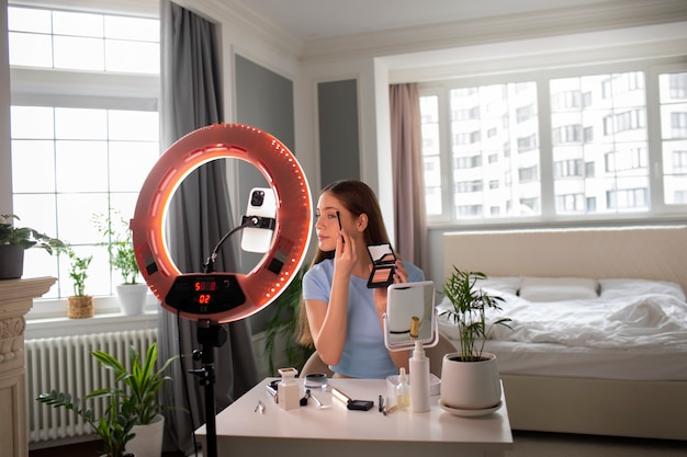 Medium shot girl recording her makeup routine