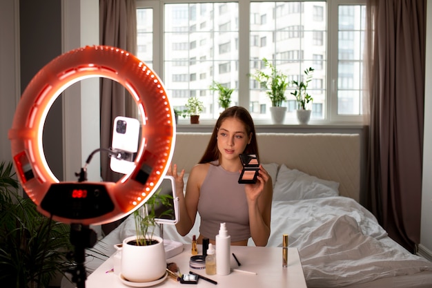 Medium shot girl recording her makeup routine