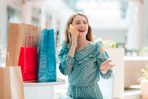 Medium shot girl next to shopping bags