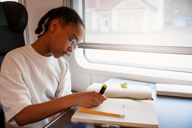 Free photo medium shot girl traveling by train