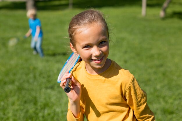 Medium shot girl with badminton racket