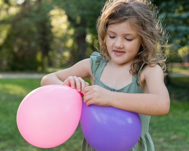 Medium shot girl with balloons