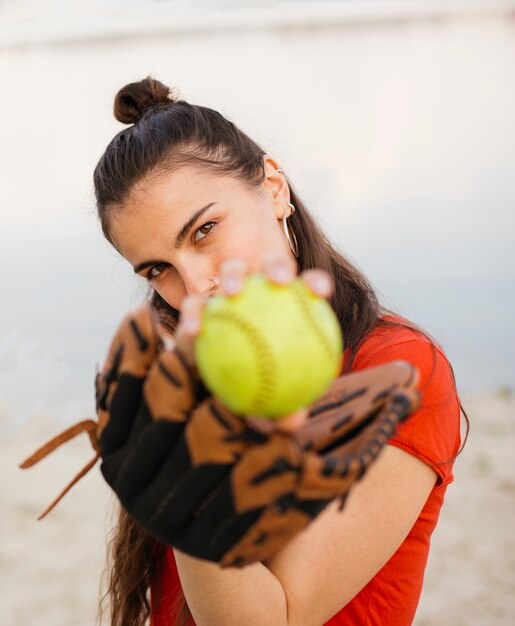 Medium shot girl with baseball glove and ball